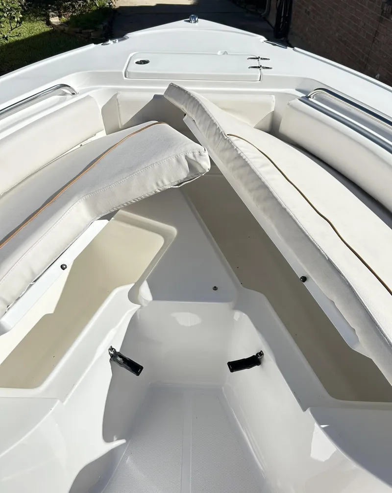 Slide: The Image of 2022 Sea Hunt Ultra 234 boat interior with white cushioned seating. - 20