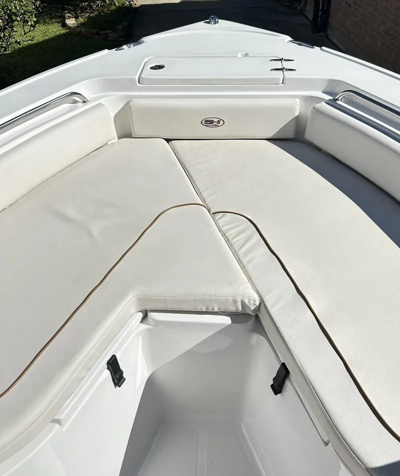 Slide: The Image of 2022 Sea Hunt Ultra 234 boat with spacious white seating area. - 21