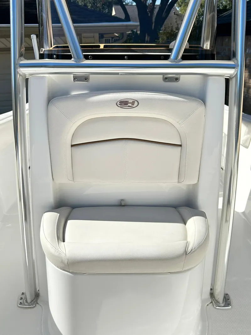Slide: The Image of 2022 Sea Hunt Ultra 234 boat seat with stainless steel frame and white upholstery. - 23