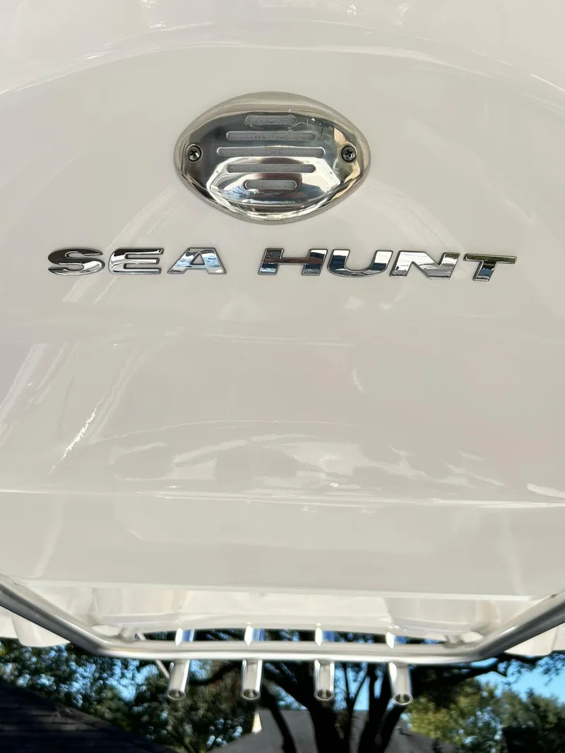 Slide: The Image of 2022 Sea Hunt Ultra 234 boat logo on white surface. - 26