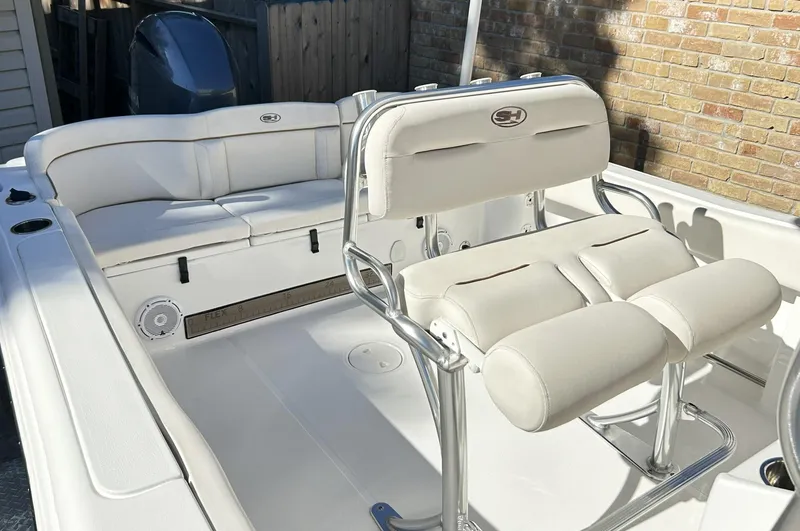 Slide: The Image of 2022 Sea Hunt Ultra 234 boat interior with white seating and sleek design. - 27