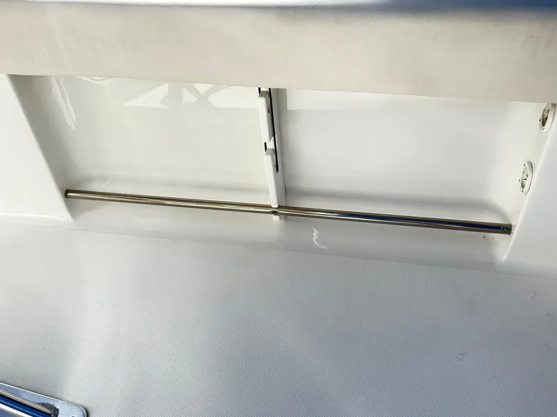 Slide: The Image of 2022 Sea Hunt Ultra 234 boat interior detail with stainless steel rod holder. - 29