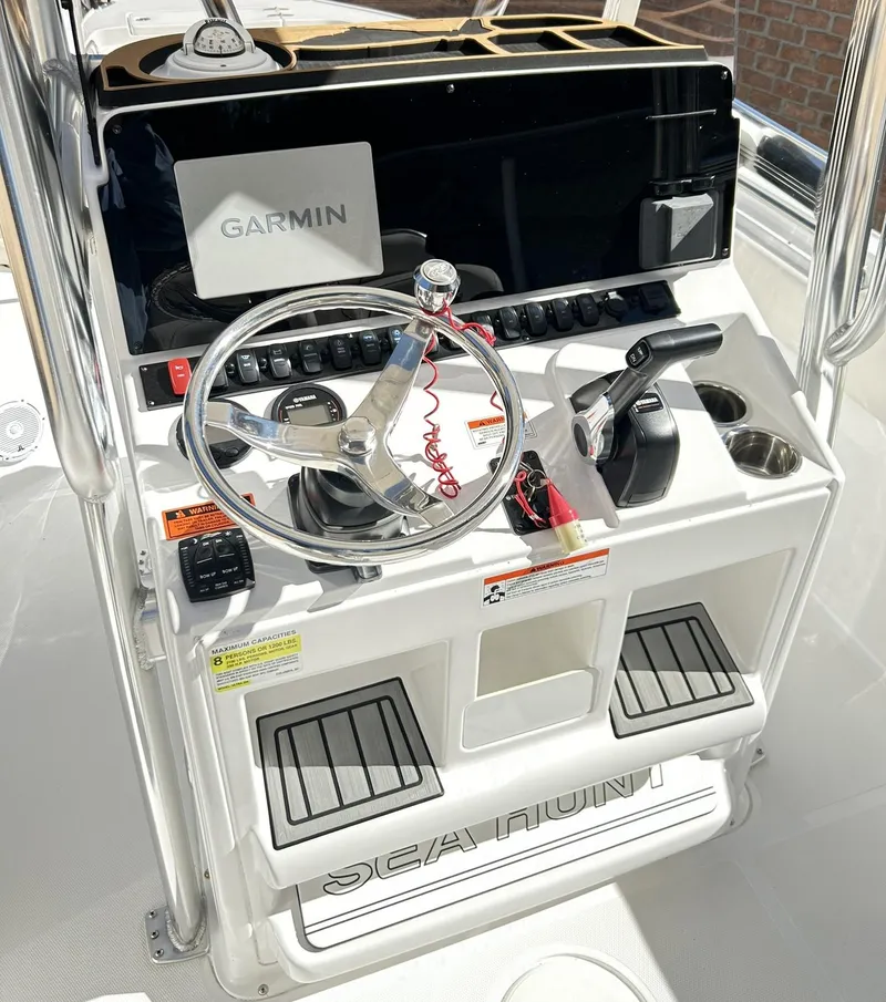 Slide: The Image of 2022 Sea Hunt Ultra 234 boat console with Garmin navigation system and steering wheel. - 3