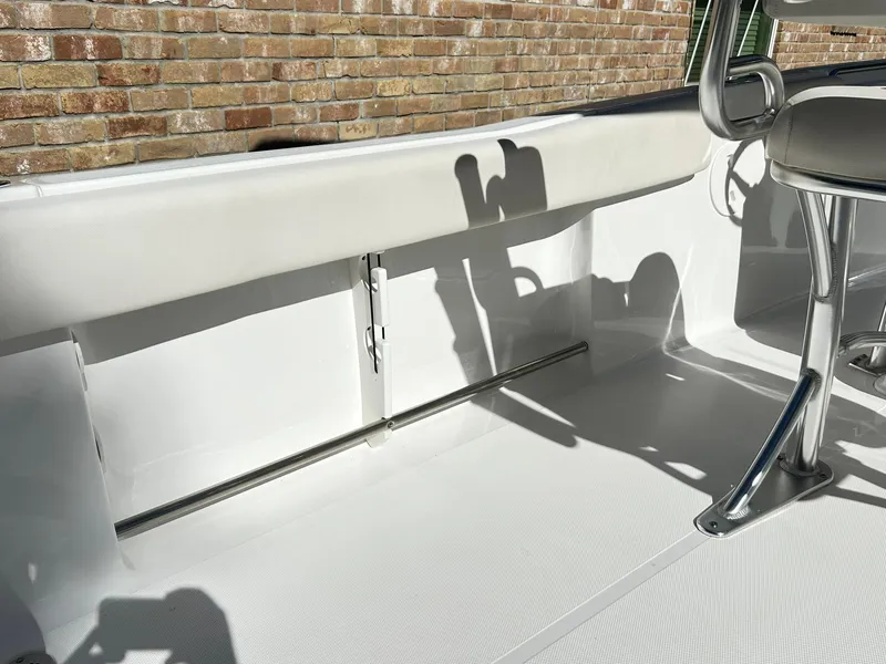 Slide: The Image of 2022 Sea Hunt Ultra 234 boat interior with seating and stainless steel fixtures. - 30