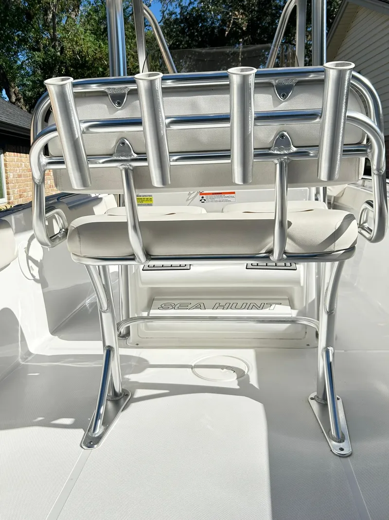 Slide: The Image of 2022 Sea Hunt Ultra 234 boat interior with rod holders and seating. - 31