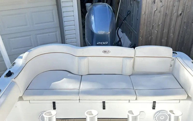 Slide: The Image of 2022 Sea Hunt Ultra 234 boat with cushioned seating and Yamaha 200 engine. - 34