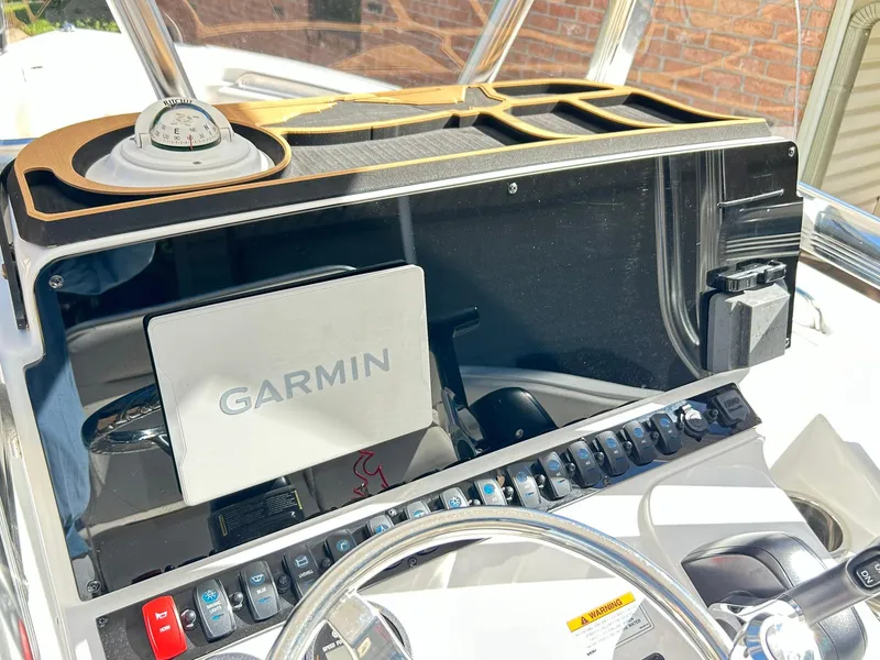 Slide: The Image of 2022 Sea Hunt Ultra 234 dashboard with Garmin navigation system and control panel. - 39
