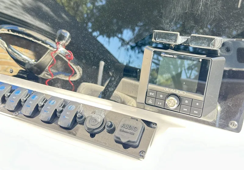Slide: The Image of Control panel of 2022 Sea Hunt Ultra 234 boat with JL Audio system. - 41