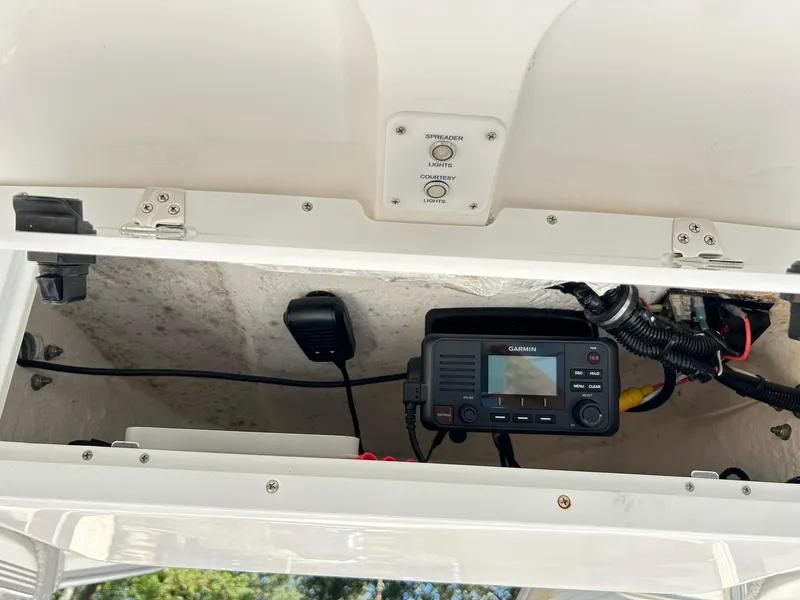Slide: The Image of 2022 Sea Hunt Ultra 234 boat console with Garmin marine radio and wiring. - 44
