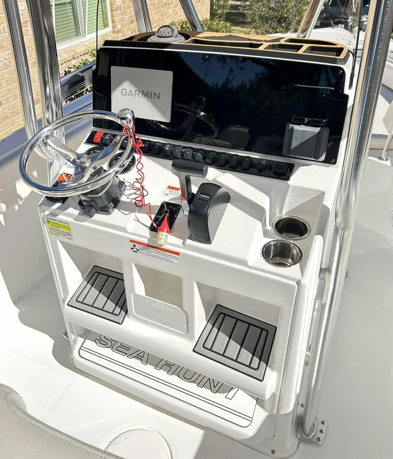Slide: The Image of 2022 Sea Hunt Ultra 234 boat console with Garmin navigation system and steering wheel. - 46
