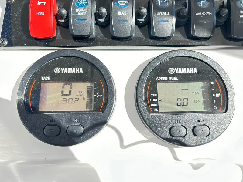 Slide: The Image of Yamaha gauges on 2022 Sea Hunt Ultra 234 boat dashboard, displaying tachometer and speed/fuel data. - 47
