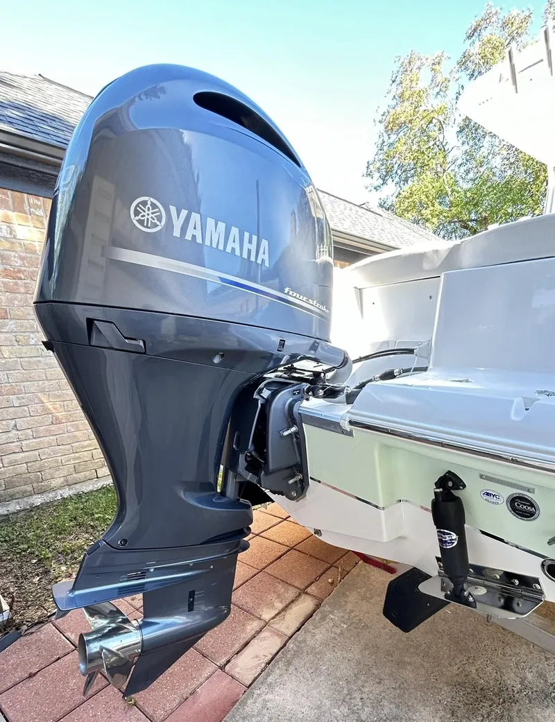 Slide: The Image of 2022 Sea Hunt Ultra 234 with Yamaha outboard motor, parked on a brick driveway. - 5