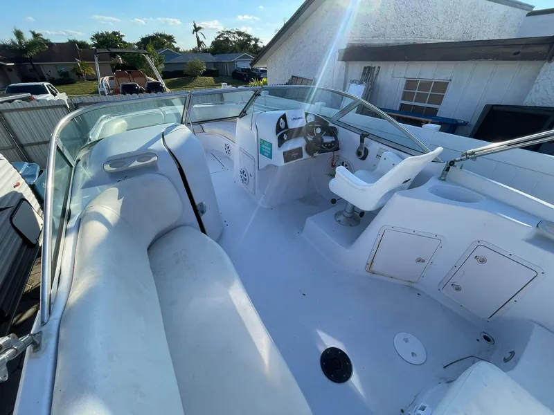 Slide: The Image of 2001 Hurricane 232 OB boat interior with seating and steering console. - 10