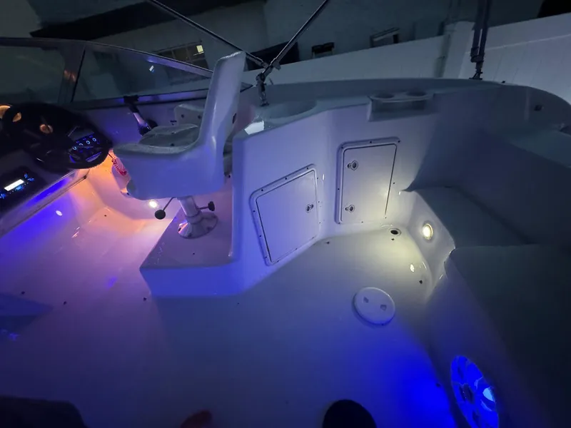 Slide: The Image of 2001 Hurricane 232 OB boat interior with ambient blue lighting. - 11