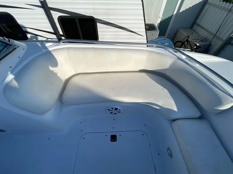 Slide: The Image of 2001 Hurricane 232 OB boat interior seating area with white upholstery. - 13