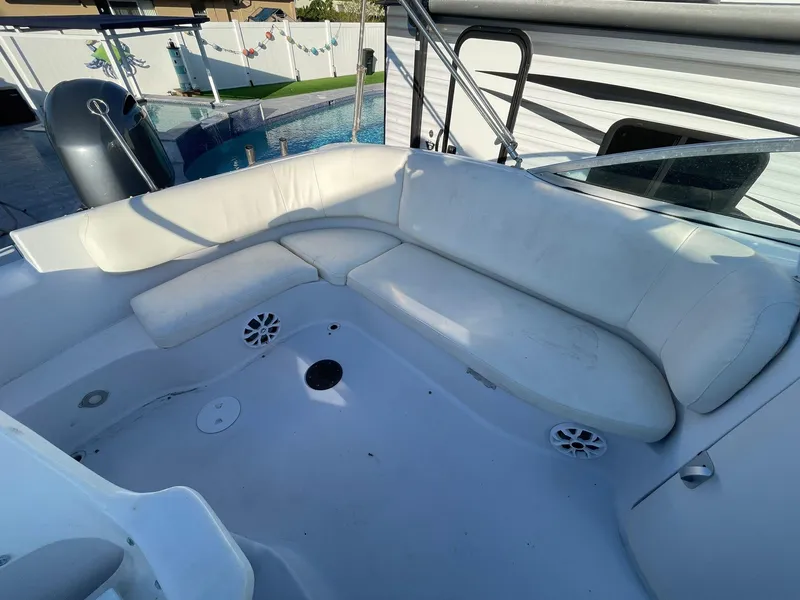 Slide: The Image of 2001 Hurricane 232 OB boat with white seating and poolside view. - 14