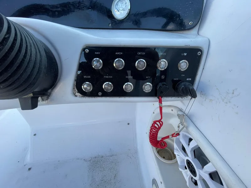 Slide: The Image of Control panel of a 2001 Hurricane 232 OB boat with switches and speaker. - 21
