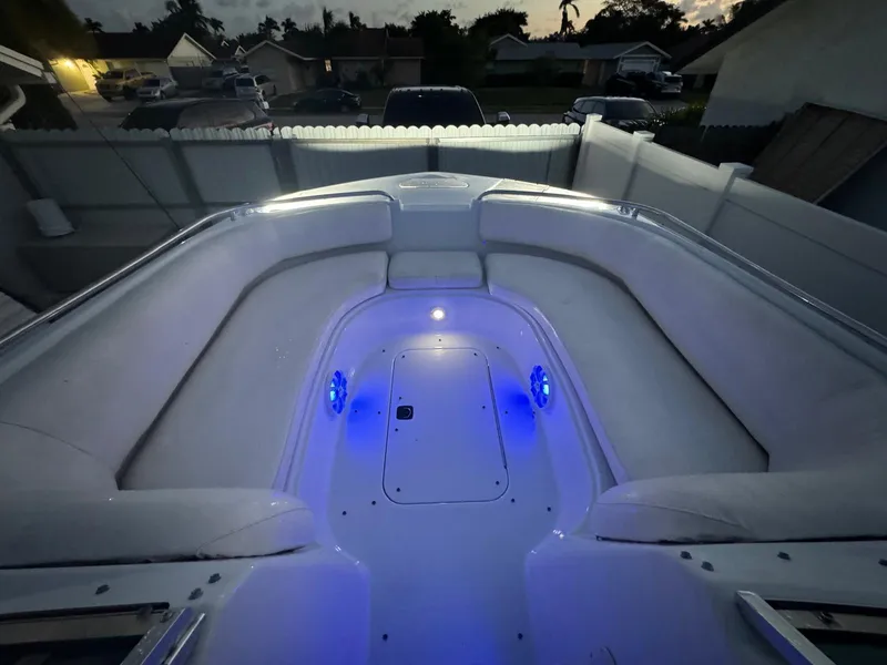 Slide: The Image of 2001 Hurricane 232 OB boat interior with blue LED lighting at dusk. - 23
