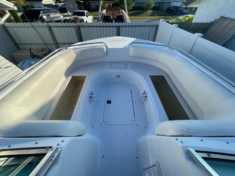 Slide: The Image of 2001 Hurricane 232 OB boat interior with white seating and storage compartments. - 24