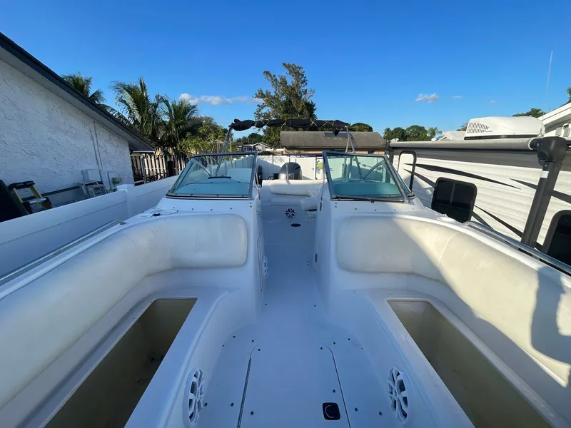 Slide: The Image of 2001 Hurricane 232 OB boat interior with white seating and clear blue sky. - 25