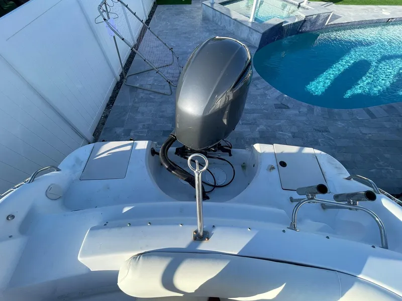 Slide: The Image of 2001 Hurricane 232 OB boat with outboard motor near a swimming pool. - 5
