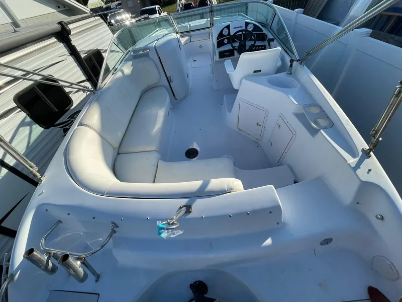 Slide: The Image of 2001 Hurricane 232 OB boat interior with white seating and steering console. - 9