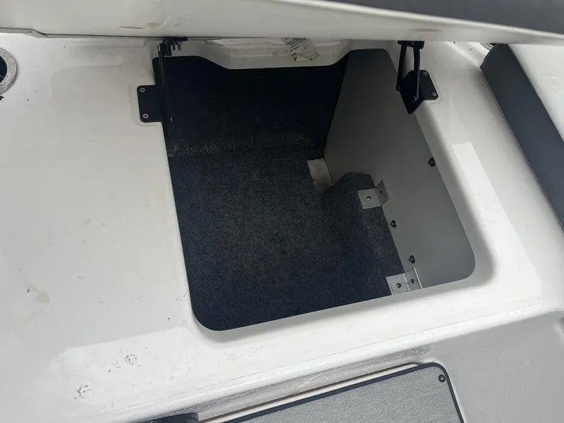 Slide: The Image of Open storage compartment in 2023 Yamaha AR250 boat. - 16