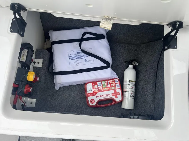 Slide: The Image of Storage compartment of 2023 Yamaha AR250 with safety gear and first aid kit. - 17