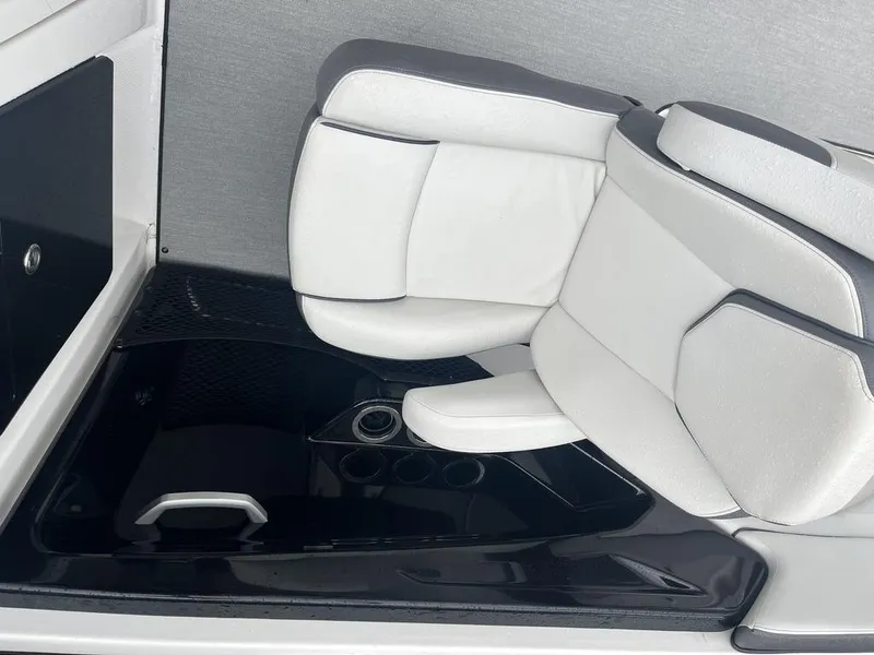 Slide: The Image of 2023 Yamaha AR250 boat interior with sleek white seating and cup holders. - 18