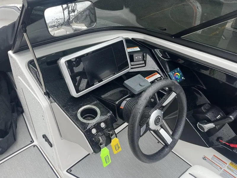 Slide: The Image of 2023 Yamaha AR250 boat dashboard with steering wheel and touchscreen display. - 19