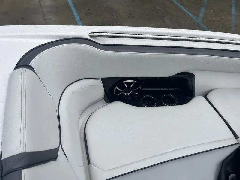 Slide: The Image of 2023 Yamaha AR250 boat interior with white cushioned seating and speaker system. - 21