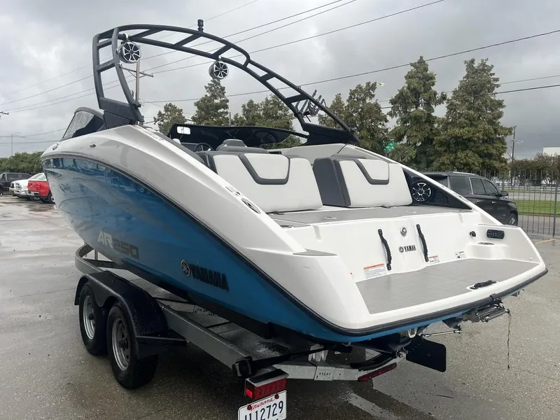 Slide: The Image of 2023 Yamaha AR250 boat on trailer, sleek design, overcast day. - 4