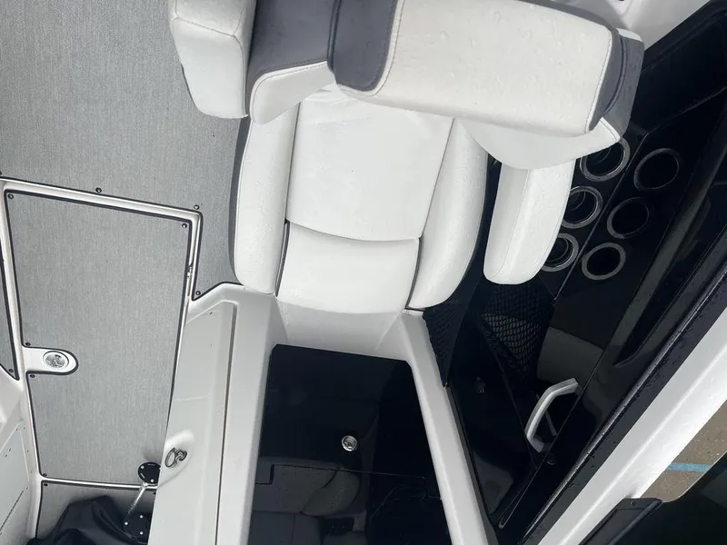 Slide: The Image of Interior of 2023 Yamaha AR250 boat with white seating and storage compartments. - 7
