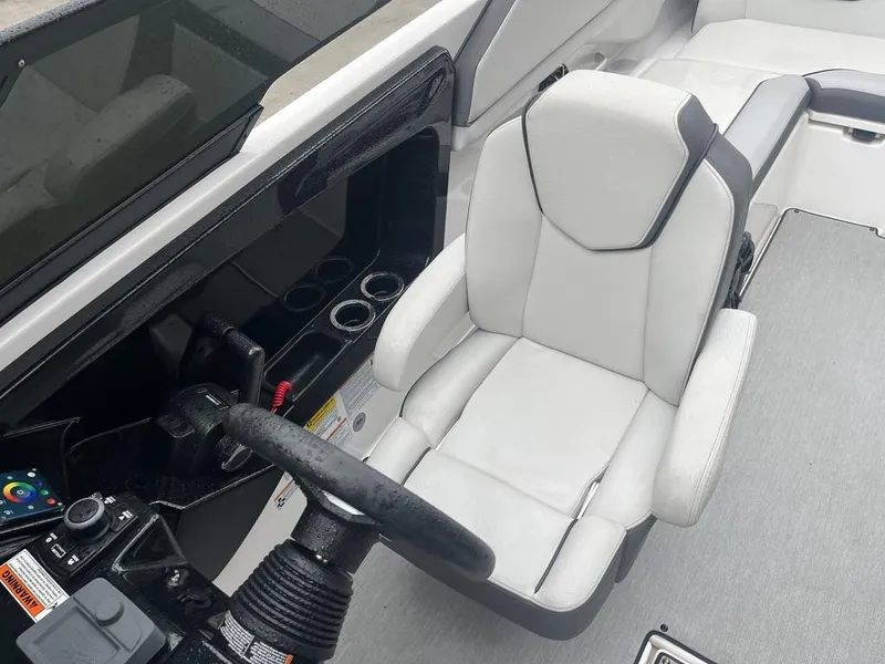 Slide: The Image of 2023 Yamaha AR250 boat interior with steering wheel and captain's seat. - 9