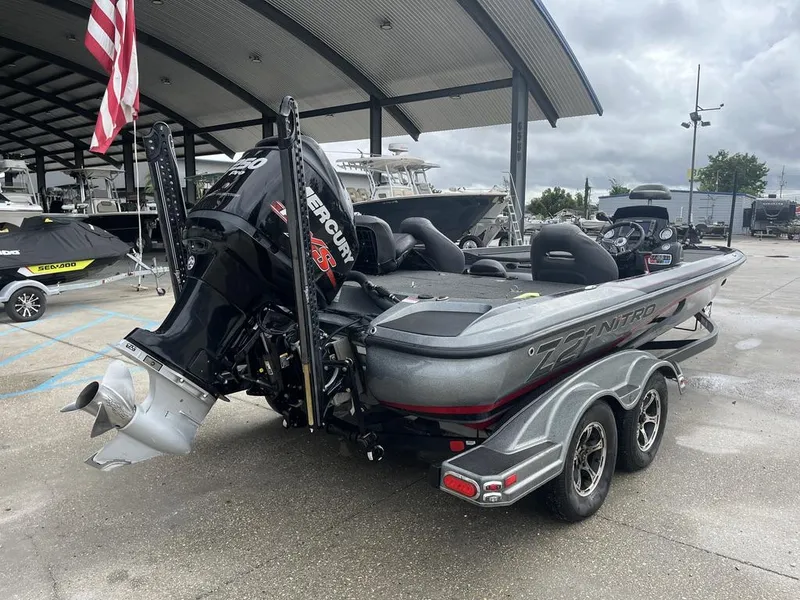 Slide: The Image of 2017 Nitro Z21 boat with Mercury engine, parked under a covered area. - 13