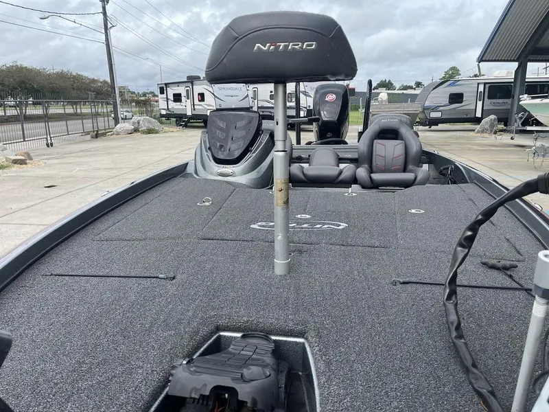 Slide: The Image of 2017 Nitro Z21 fishing boat with spacious deck and seating, parked outdoors. - 15