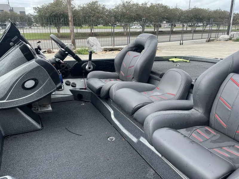 Slide: The Image of 2017 Nitro Z21 boat interior with gray and red seats. - 16