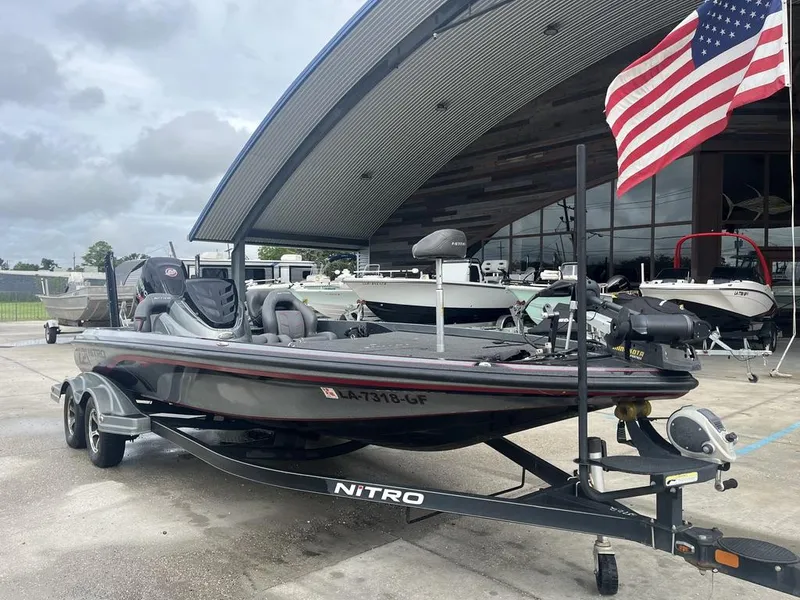 Slide: The Image of 2017 Nitro Z21 boat on trailer, parked outside with American flag. - 3