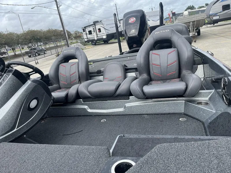 Slide: The Image of 2017 Nitro Z21 boat interior with gray seats and steering wheel. - 7