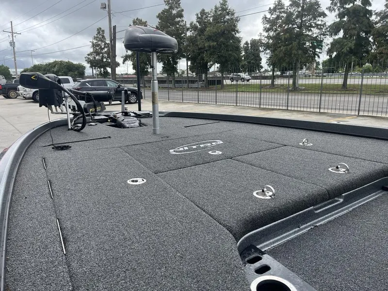 Slide: The Image of 2017 Nitro Z21 boat deck with fishing equipment, parked outdoors. - 8