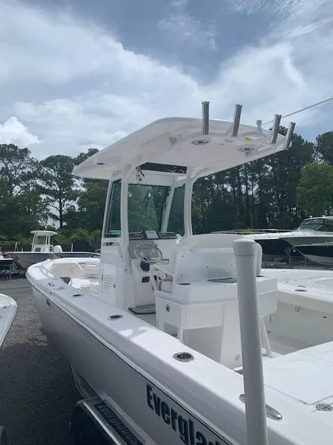Slide: The Image of 2021 Everglades 253 Center Console boat with T-top, docked outdoors. - 5
