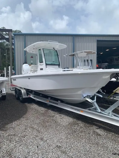 Slide: The Image of 2021 Everglades 253 Center Console boat on trailer outside a warehouse. - 7