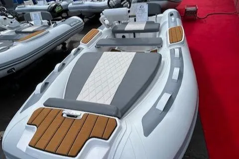 The Image of 2025 Gala Electric Atlantis Aquahelm boat with sleek design and wooden accents. - 0