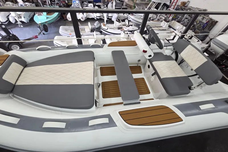 Slide: The Image of 2025 Gala A360HQ ELECTRIC boat interior with gray and white seating, wooden flooring. - 4