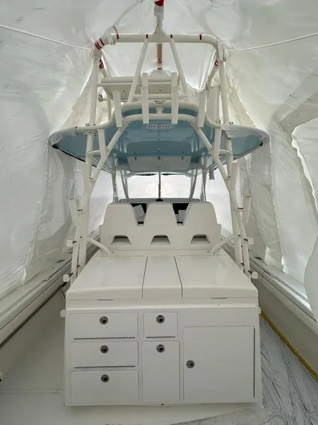 Slide: The Image of 2016 Regulator 41 boat interior with white seating and storage cabinets. - 19