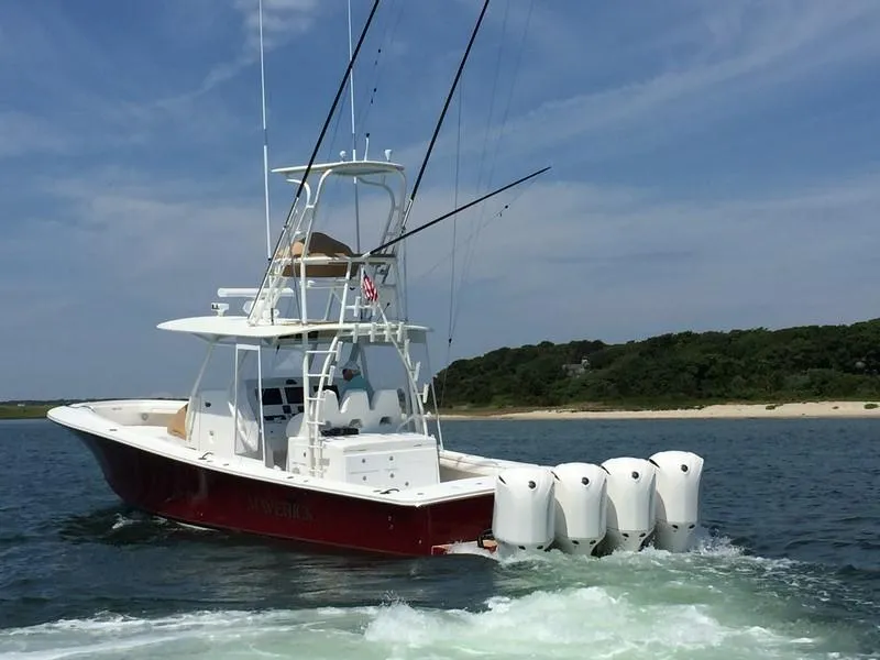 Slide: The Image of 2016 Regulator 41 boat with four engines cruising on water. - 2