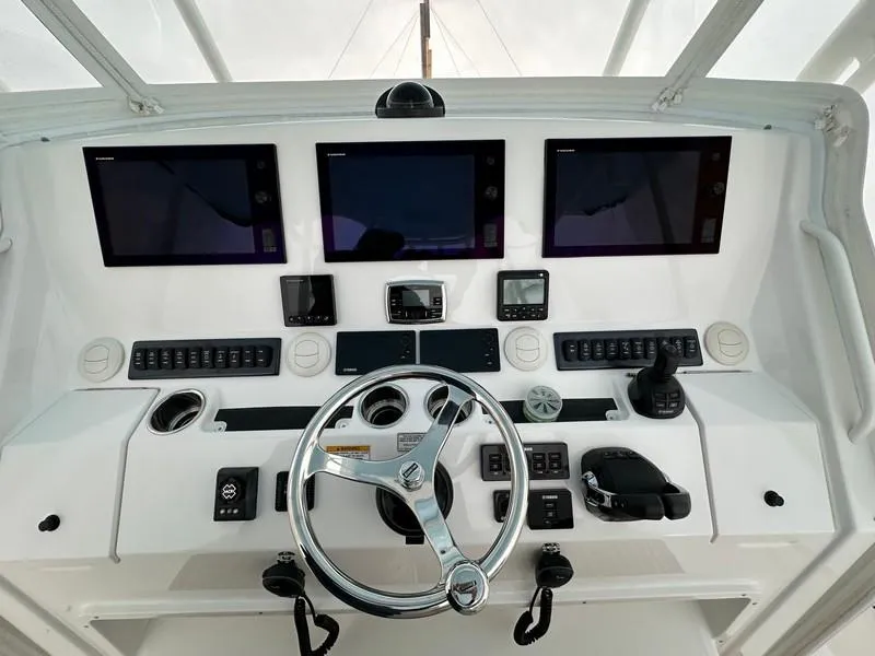 Slide: The Image of 2016 Regulator 41 boat dashboard with modern navigation equipment and steering wheel. - 20