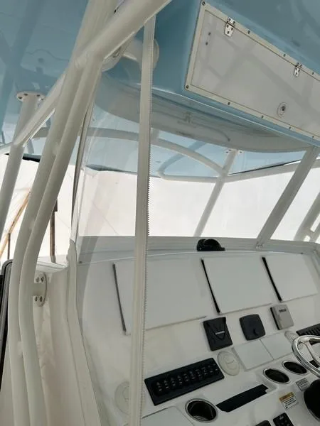 Slide: The Image of 2016 Regulator 41 boat cockpit with modern controls and blue canopy. - 22