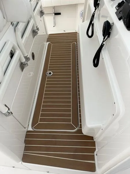 Slide: The Image of 2016 Regulator 41 boat interior with teak flooring and white seating. - 23