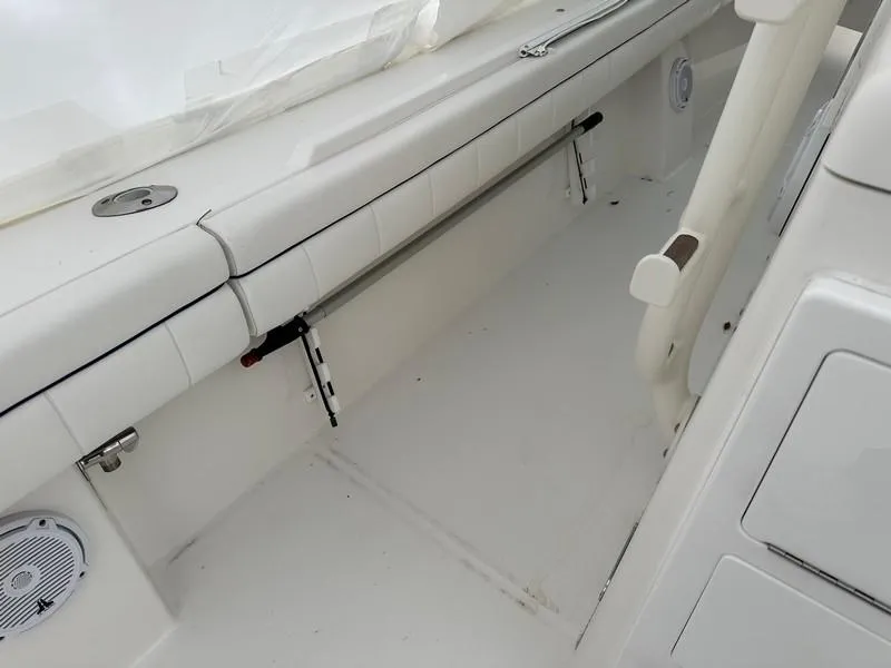 Slide: The Image of 2016 Regulator 41 boat interior with white seating and storage compartments. - 27